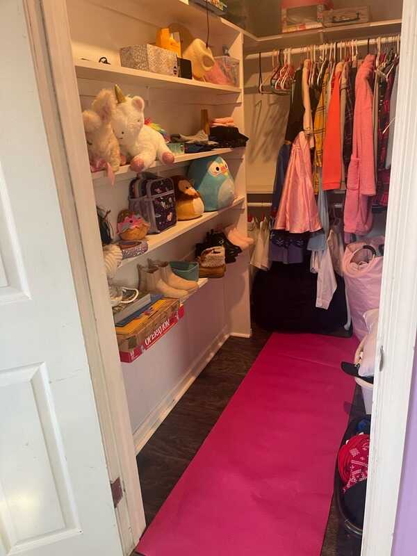 The same closet with clothes hung up and the floor cleared