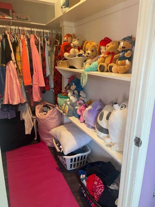 Closet shelves with clothes and toys organized